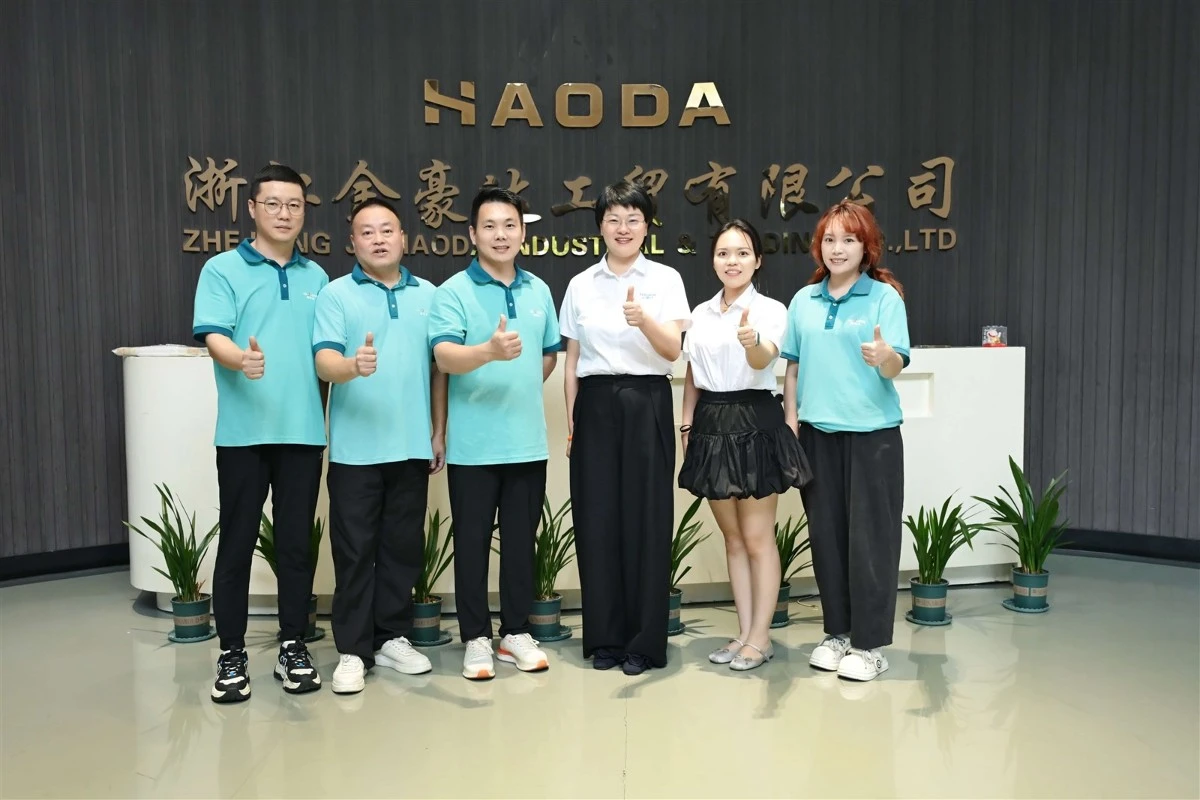 Zhejiang Jinhoda leadership team posing with Great Dragon Optical representatives in front of the company sign at headquarters Zhejiang Jinhoda leadership team posing with Great Dragon Optical representatives in front of the company sign at headquarters